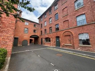 Offered to the market via auction is this unique and spacious loft-style duplex apartment, set within the impressive Grade II listed Tean Hall Mills development. Converted in 2013 to a high standard, the property is situated in the former Warehouse building and retains many original features including exposed beams, cast iron pillars, and vaulted ceilings.