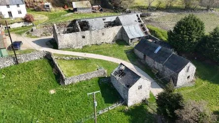 A farm house set in 9.56 acres with an extensive range of barns providing great potential for development.