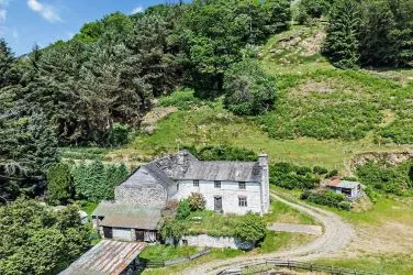 A farm house set in 9.56 acres with an extensive range of barns providing great potential for development.