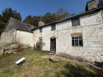 A farm house set in 9.56 acres with an extensive range of barns providing great potential for development.