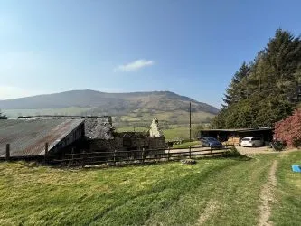 A farm house set in 9.56 acres with an extensive range of barns providing great potential for development.