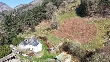 A farm house set in 9.56 acres with an extensive range of barns providing great potential for development.