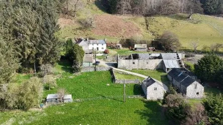A farm house set in 9.56 acres with an extensive range of barns providing great potential for development.
