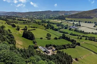 A farm house set in 9.56 acres with an extensive range of barns providing great potential for development.