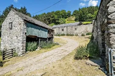 A farm house set in 9.56 acres with an extensive range of barns providing great potential for development.