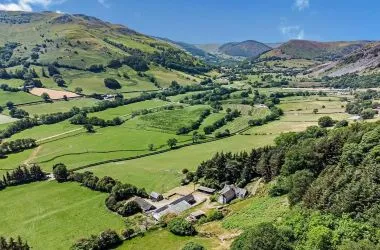 A farm house set in 9.56 acres with an extensive range of barns providing great potential for development.