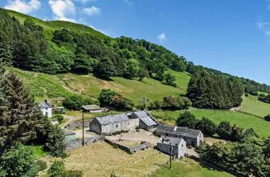 A farm house set in 9.56 acres with an extensive range of barns providing great potential for development.