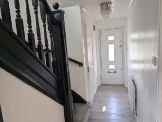 A well-proportioned, detached three-bedroom home with garage and conservatory, located in a quiet residential setting.