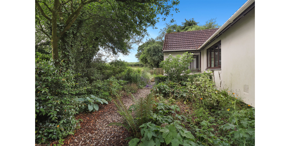 3 Bedroom detached bungalow in a peaceful village location with parking, garage and private wraparound gardens