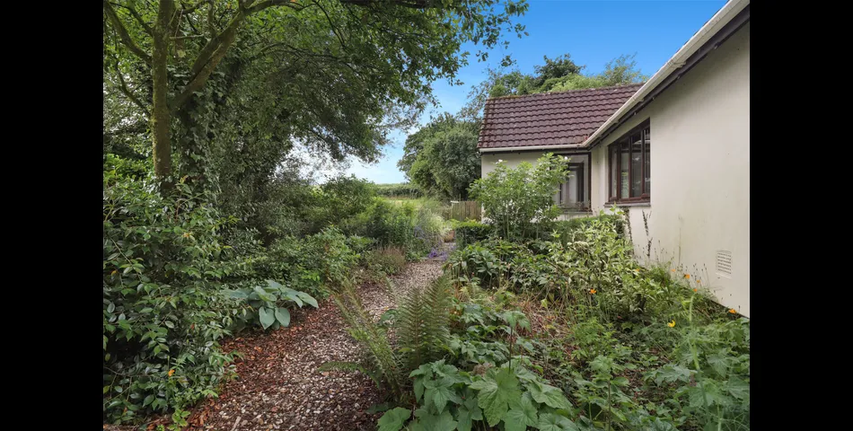 3 Bedroom detached bungalow in a peaceful village location with parking, garage and private wraparound gardens