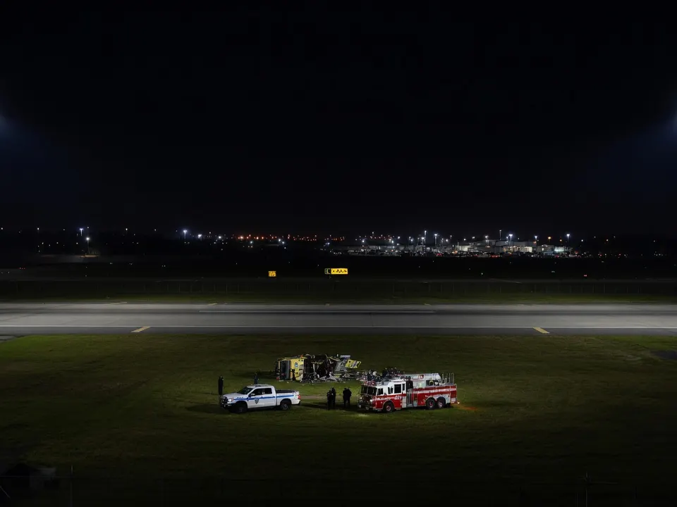 Hulpdiensten staan na de dodelijke botsing op een baan van luchthaven LaGuardia