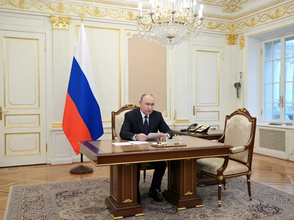 De Russische president Vladimir Poetin aan zijn bureau in een staatsgebouw