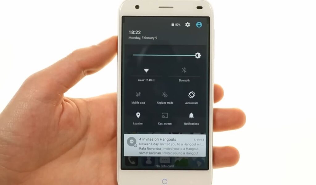The ZTE Blade S6 smartphone held in hand, showing the notification pane