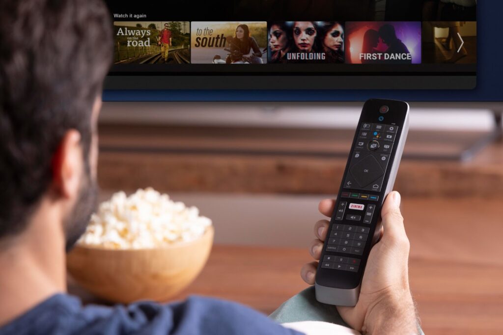 A man chooses what movie to watch