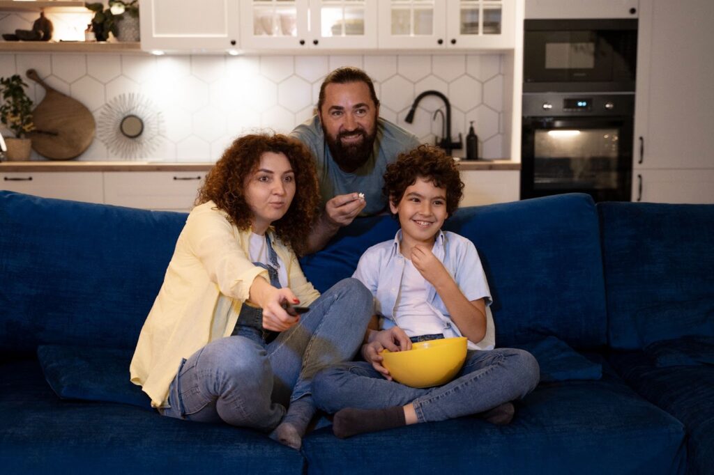 Close up on child watching movies with parents