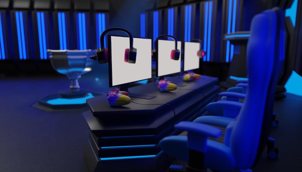 a room in blue light with three monitors, gaming chairs, and a winner trophy statue