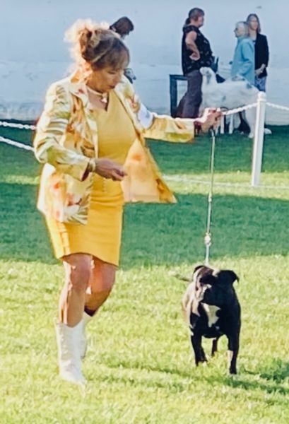 Lorene Wilson with her dog on a leash.