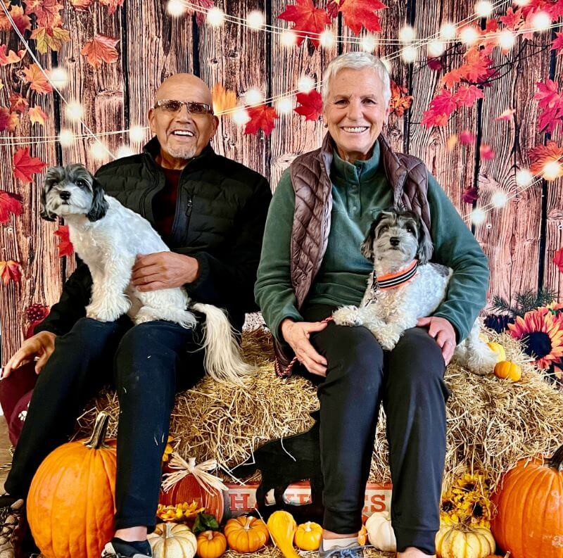 Two people with their dogs.