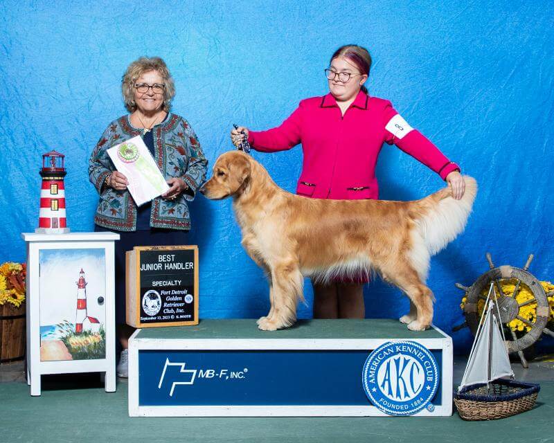 Mary Grace Kocab holding her dog on a stage.