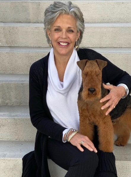 Keith Bailey with her Welsh Terrier in her lap.