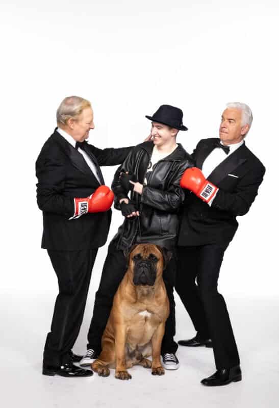 CELEBRATING ROCKYFEST 2024 - National Dog Show Presented by Purina co-hosts David Frei (l) and John O’Hurley (r) celebrate RockyFest 2024, the newly-minted Philadelphia tourism initiative coming this December in the City of Brotherly Love. Philadelphia Visitor Center Corp. Rocky impersonator Jordan Coimbra and National Dog Show competing Bullmastiff Rufus play Sylvester Stallone’s Rocky and his trusted companion and training partner, Butkus, during a September promotional photo session. Kennel Club of Philadelphia Bullmastiffs will make multiple appearances at the November 16-17 dog shows and at the December 3-8 RockyFest, representing Butkus, one of the iconic movie’s most memorable characters. RockyFest information is available at: https://phlvisitorcenter.com/rockyfest. Photo Credit: Simon Bruty/National Dog Show.