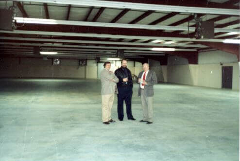 First Christmas party in the new building. Pictured left to right: Terry Mathis, James Reid, and Bud Samples.