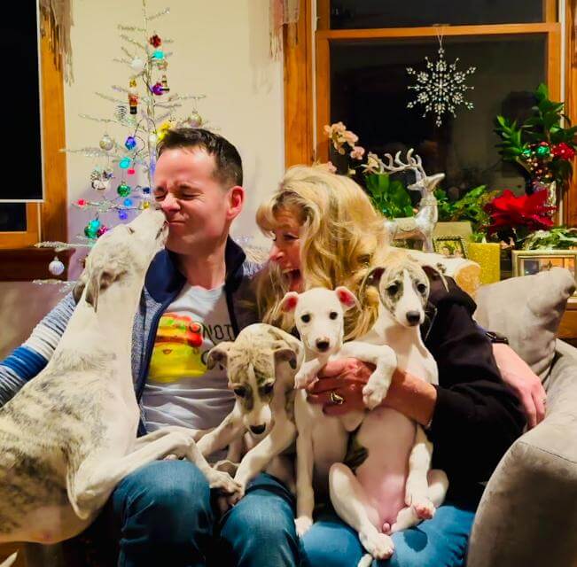 Joe and Karen Roberson on one of many failed attempts at a 2024 Christmasphoto with their new litter