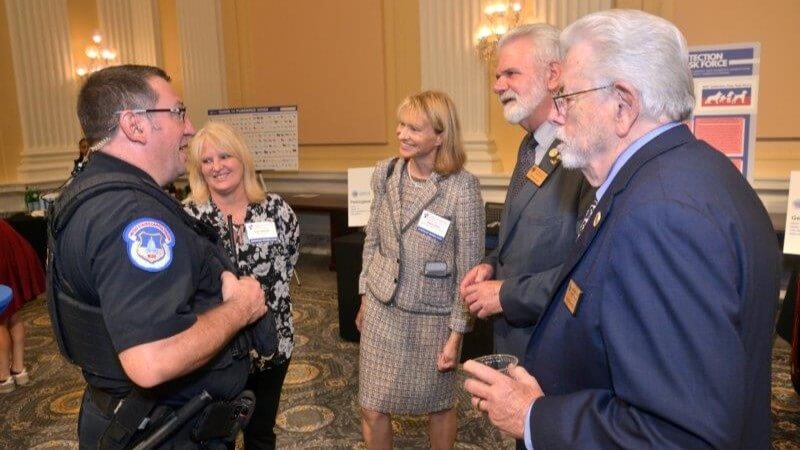 U.S. Capitol Police Officer Andrew Mayo, AKC President and CEO Gina DiNardo, AKC Executive Secretary and VP of Government Relations Sheila Goffe, AKC Board Member Chris Sweetwood, and Tom Powers
