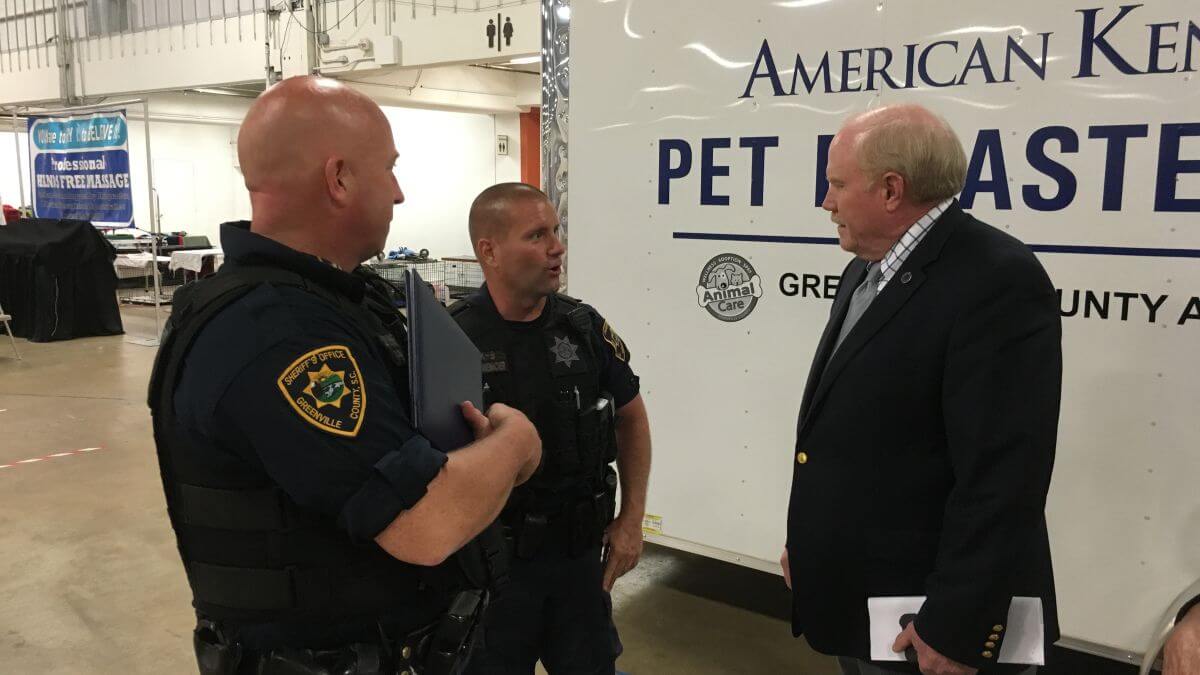 AKC Executive Vice President Doug Ljungren discusses disaster relief trailer with K-9 Officers