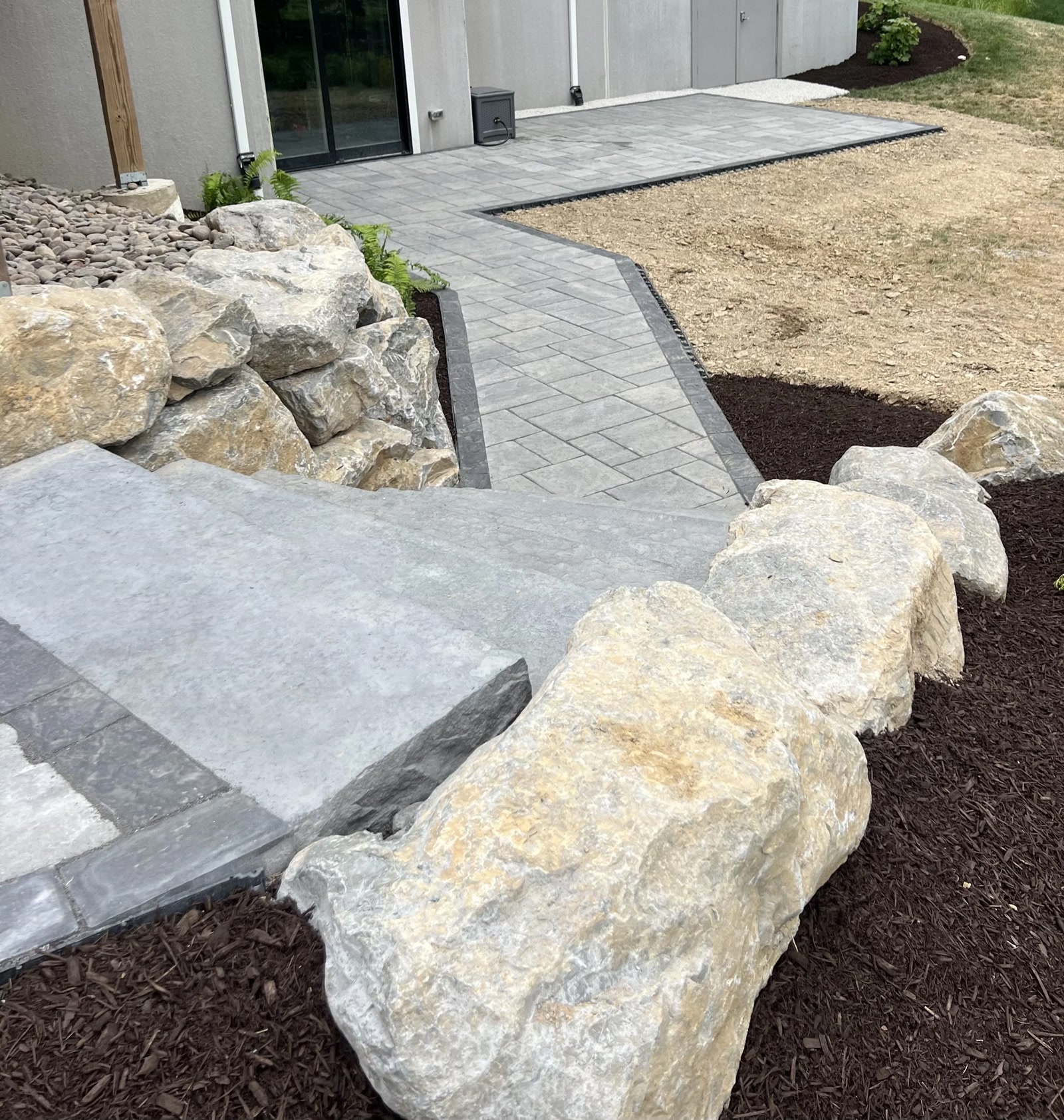 Paver walkway with boulder edging