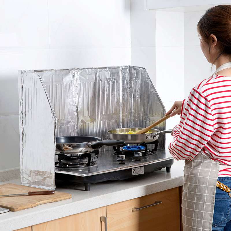 Aluminum Foil Oil Deflector on Kitchen Hearth for Cooking