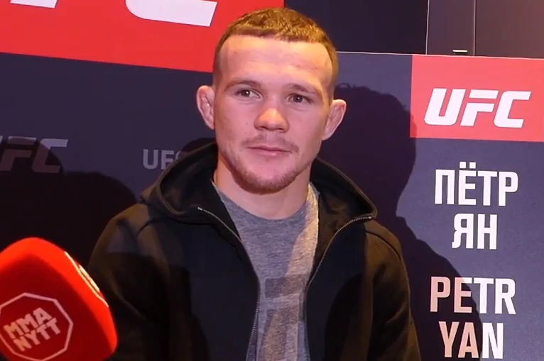 Petr Yan at a UFC media event in front of a branded backdrop