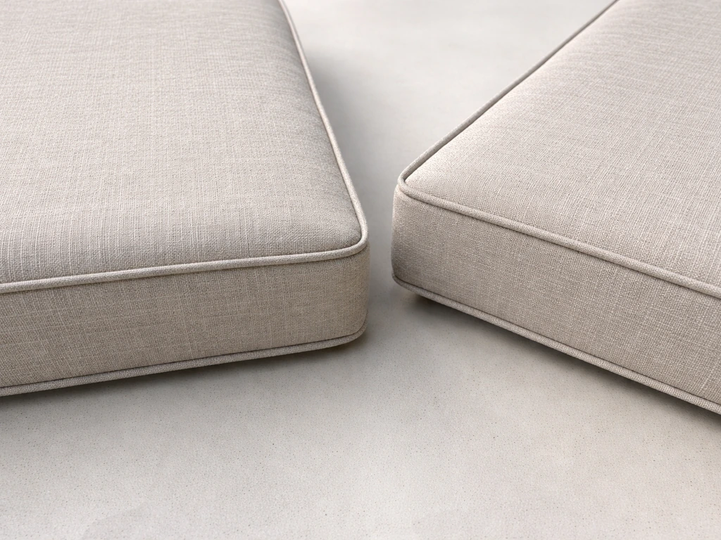 Closeup of two replacement patio cushions showing fabric texture and matched color and stitching.