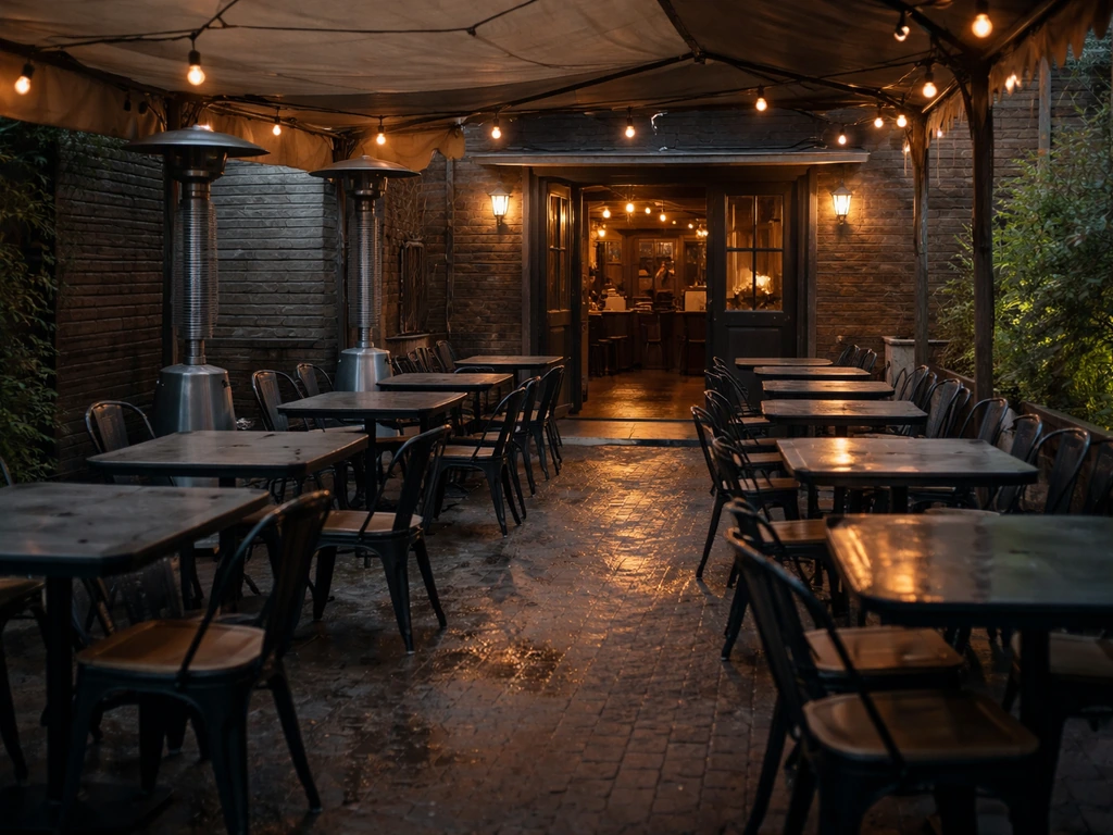 Open-air Pub Milos patio with uncovered seating and cool-weather vibe, indoor dining door in background.