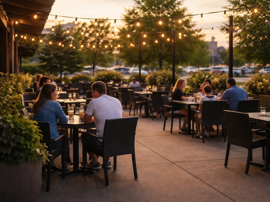 Outdoor patio at a Kanata Centrum restaurant with adults seated at tables under soft evening lights.