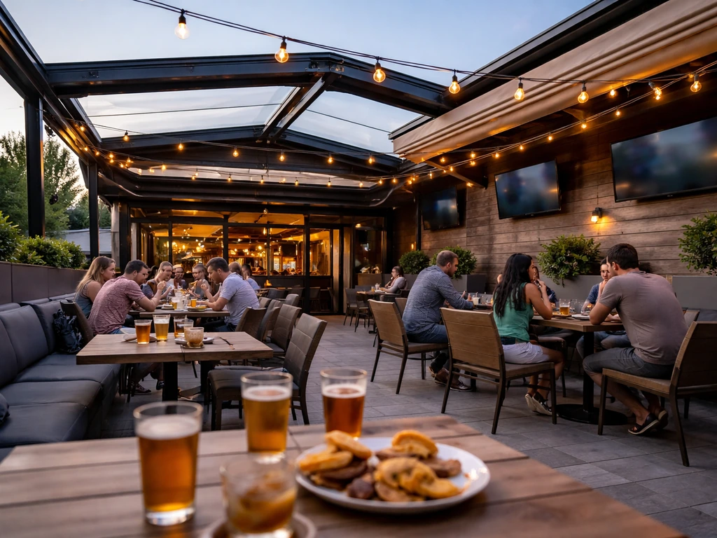 People’s-view of a cozy rooftop patio with retractable canopy open at a lively sports bar