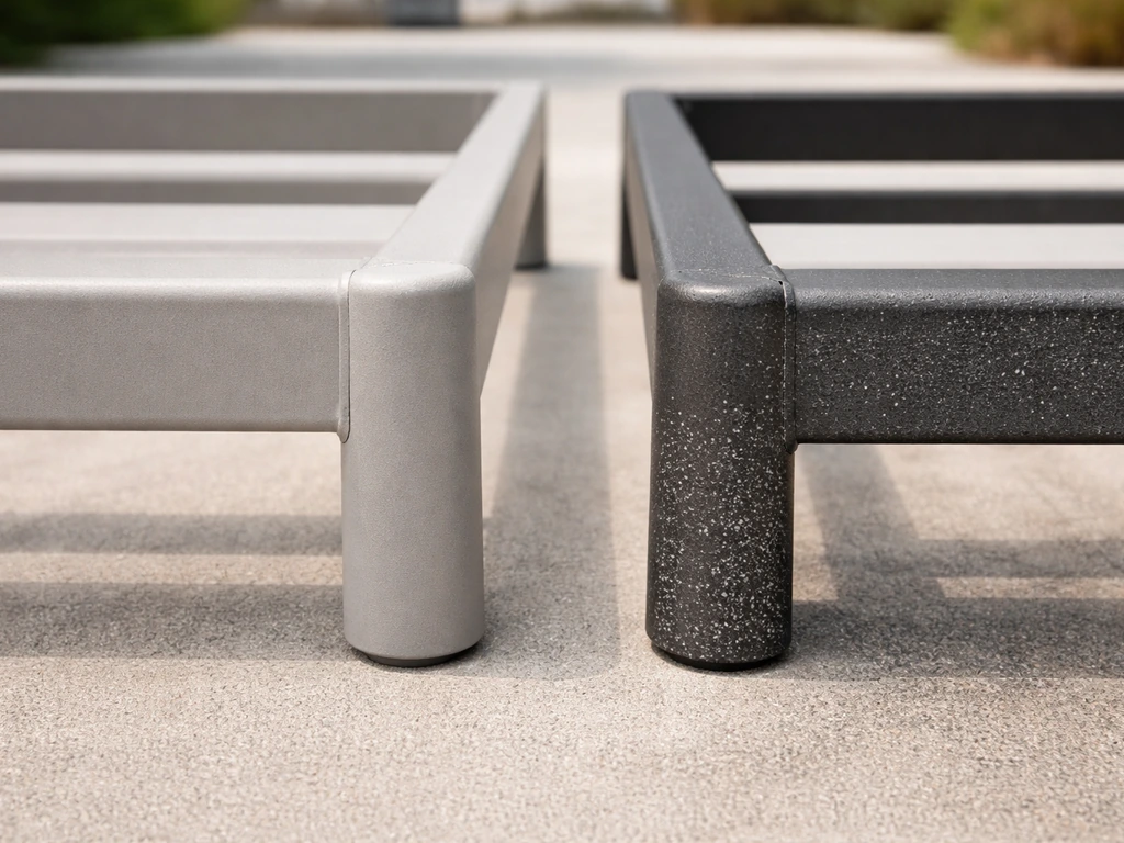 Close-up of powder-coated aluminum and steel outdoor frame sections side-by-side on concrete