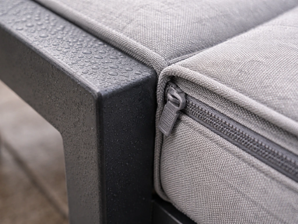 Close-up of a water-protected furniture seam: sealed welded joint and water-resistant cushion zipper.