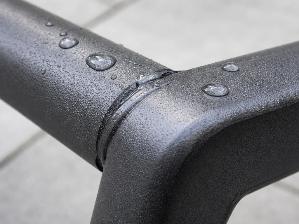 Close-up of a powder-coated aluminum frame joint with water droplets beading on the finish.