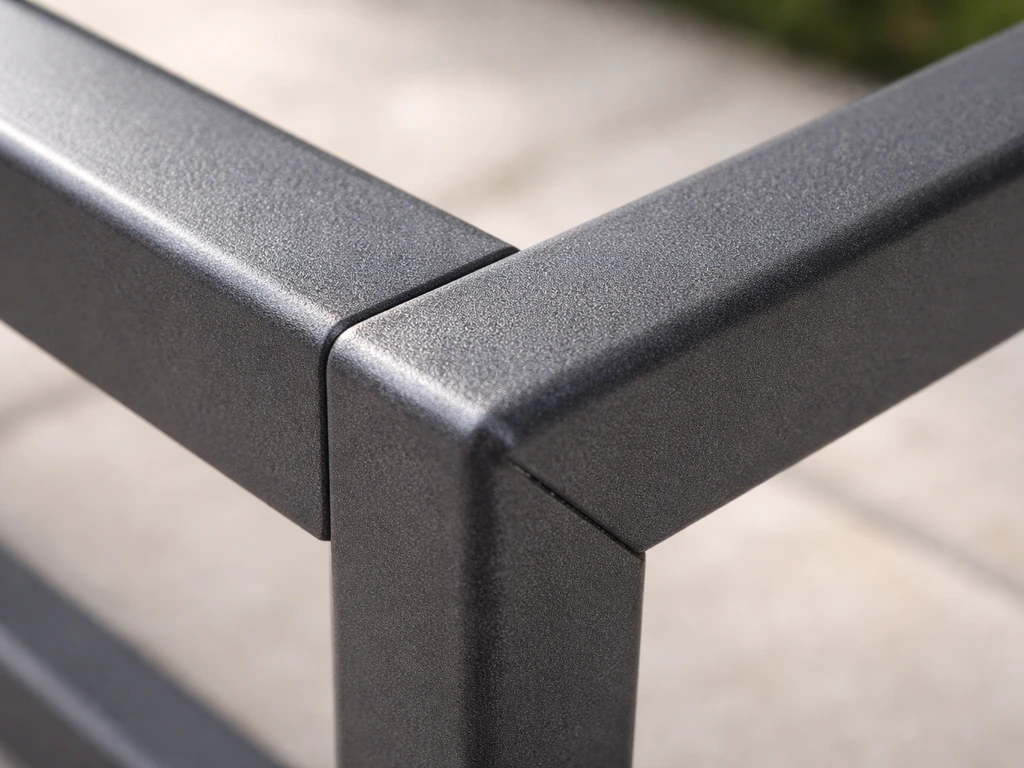 Close-up of intact powder-coated aluminum patio furniture frame showing smooth coating texture at joints.