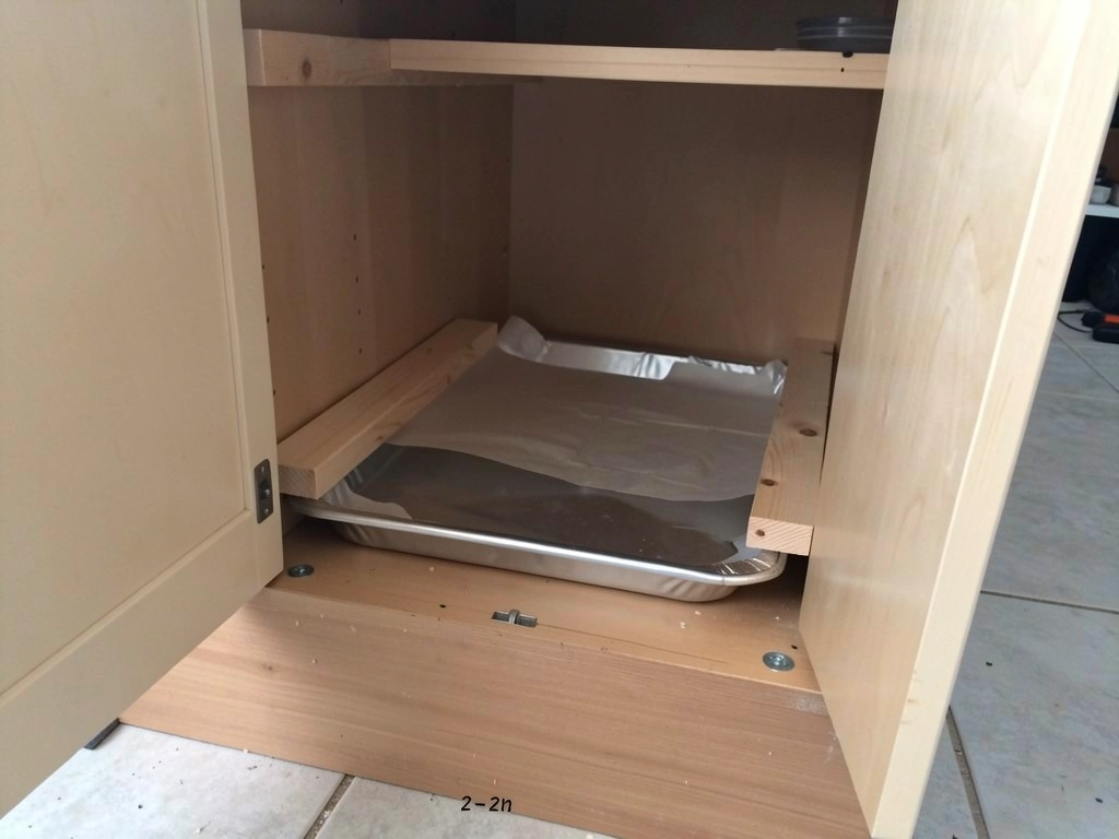 Pull-out droppings tray rails mounted inside the cabinet with tray sliding in smoothly
