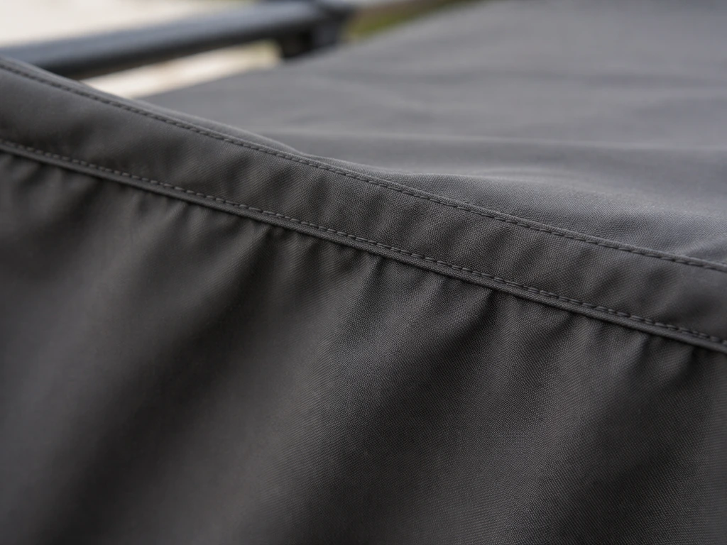 Close-up of an outdoor cover fabric sagging in the middle, pulled taut with a neatly re-tucked top flap