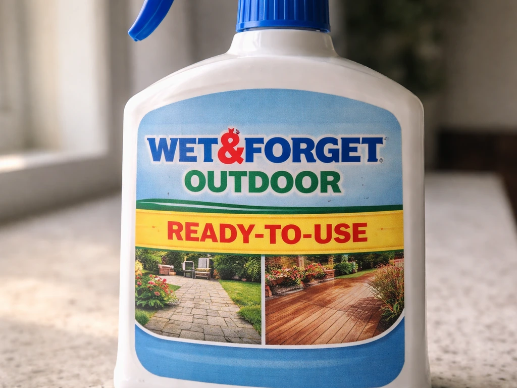 Close-up of Wet & Forget Ready-to-Use patio cleaner spray bottle packaging on a kitchen counter.