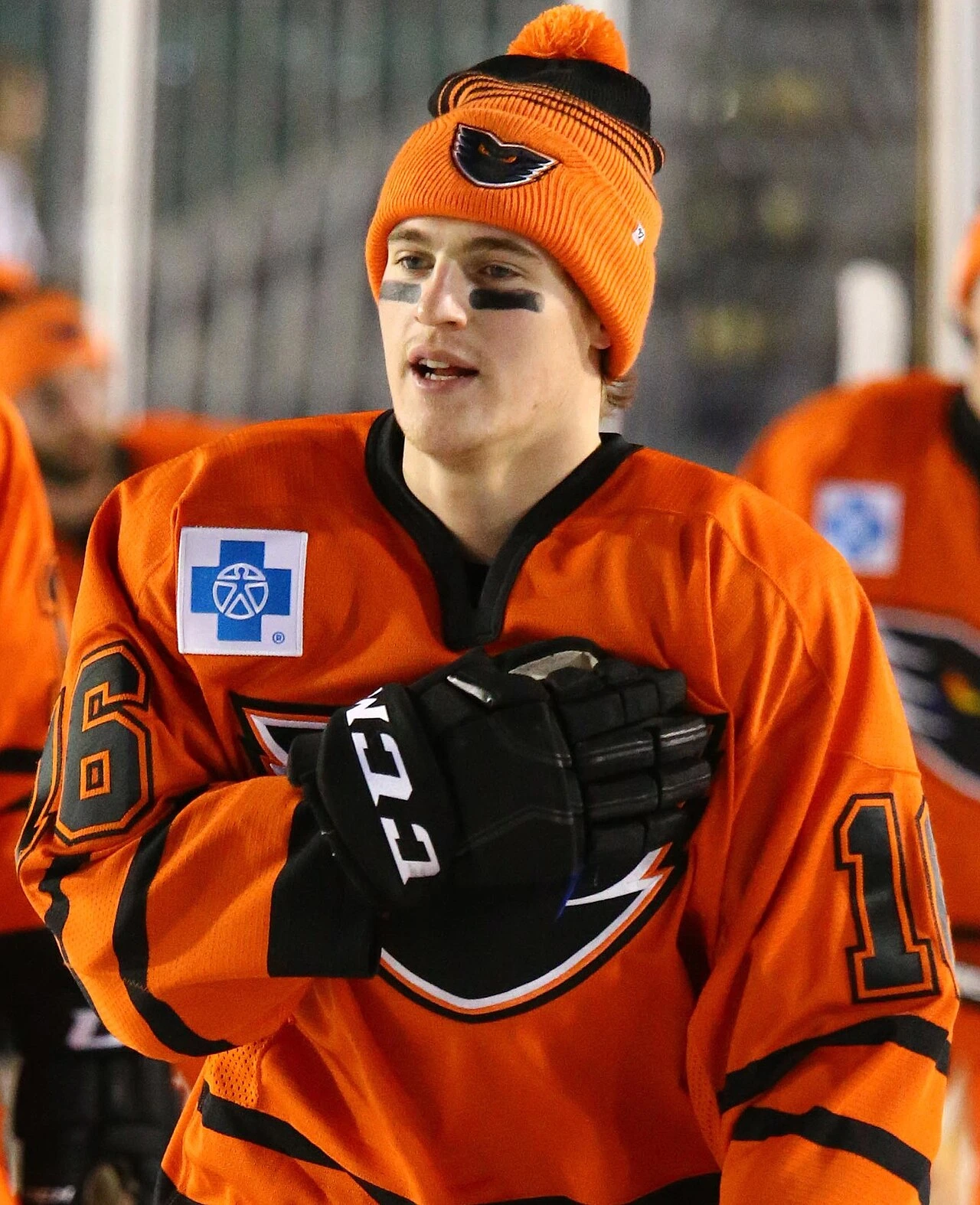 Nicolas Aubé-Kubel in an orange hockey jersey and knit hat during pregame warmups