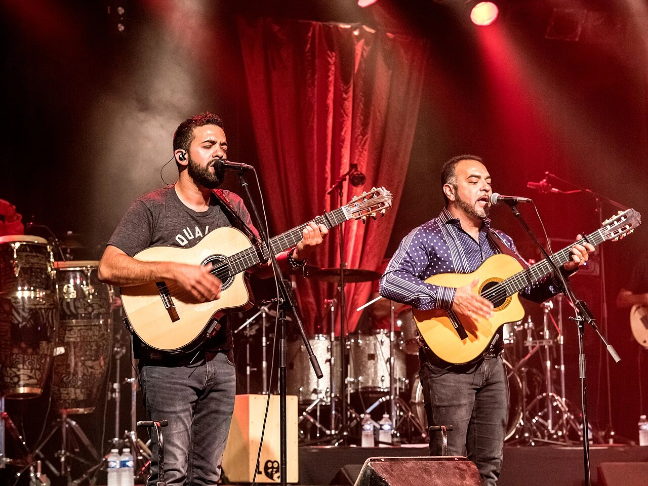 Gipsy Kings performing live on stage with guitars
