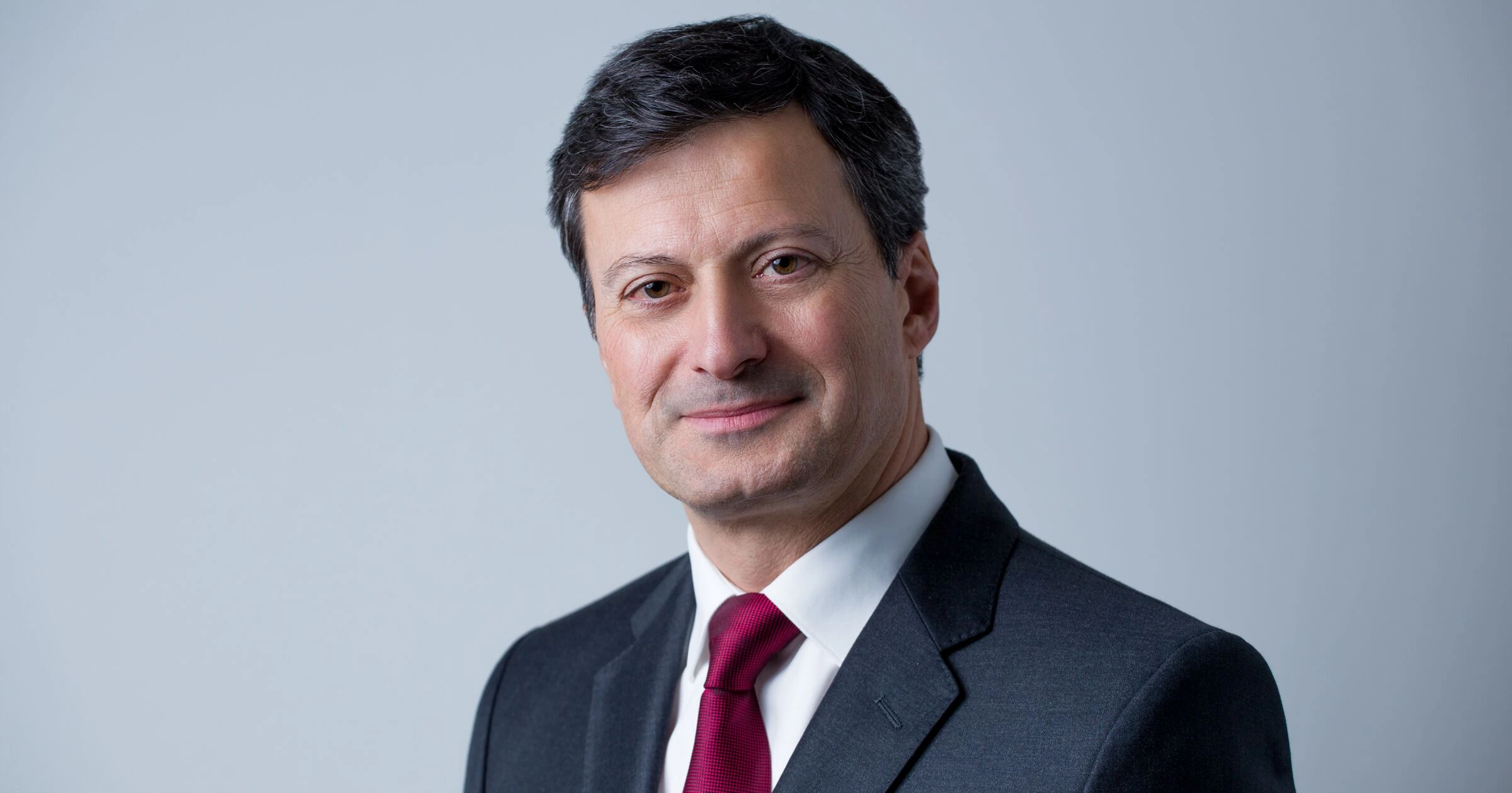 Portrait photo of Nicolas Walewski, London-based fund manager and entrepreneur, in a suit and tie against a plain backgr
