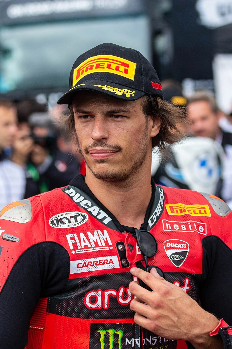 Nicolo Bulega in Ducati racing gear and Pirelli cap at a motorsport event