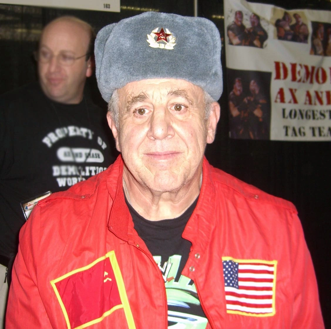Nikolai Volkoff in a red jacket and Soviet-style fur hat at an event