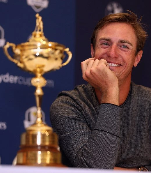 Nicolas Colsaerts smiling beside the Ryder Cup trophy