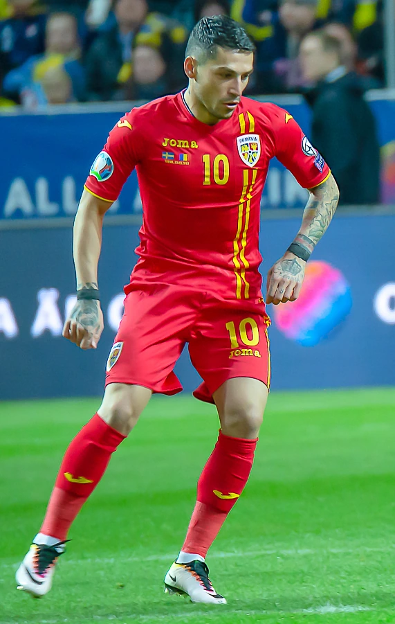 Nicolae Stanciu in a Romania national team match, wearing a red kit and number 10.